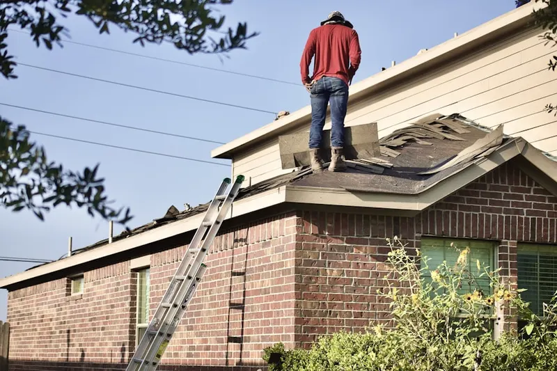 Professional roofer working on a residential roof in Lombard